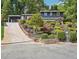 Inviting two-story home featuring a well-manicured front yard with colorful landscaping and a long driveway at 2139 Cedarbrook Court South East, Atlanta, GA 30316