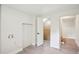 Bright hallway with light wood-look floors, a closet and access to more rooms within the home at 2139 Cedarbrook Court South East, Atlanta, GA 30316