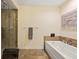 Bright bathroom showcases a modern glass-enclosed shower and a separate soaking tub at 270 17Th Nw St # 1113, Atlanta, GA 30363