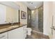 Bathroom featuring granite countertops, shower with glass doors, and tiled flooring at 270 17Th Nw St # 1113, Atlanta, GA 30363