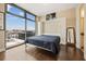 Bright bedroom featuring a Murphy bed, wood floors, and a large window with city views at 270 17Th Nw St # 1113, Atlanta, GA 30363