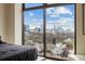 View from bedroom features a panoramic city skyline view framed by a large window at 270 17Th Nw St # 1113, Atlanta, GA 30363