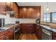 Open concept kitchen featuring stainless steel appliances, dark cabinetry, and granite countertops at 270 17Th Nw St # 1113, Atlanta, GA 30363