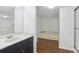 Bathroom featuring a dark vanity with granite countertop, and a walk-in shower and soaking tub at 49 Willow Gln, Atlanta, GA 30342