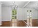 Dining room with natural light, hardwood floors, and mirrored wall at 49 Willow Gln, Atlanta, GA 30342