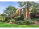Exterior of a multi story red brick home surrounded by green trees and green grass at 49 Willow Gln, Atlanta, GA 30342