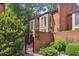Brick exterior showcases a private entrance with an iron gate, surrounded by greenery at 49 Willow Gln, Atlanta, GA 30342
