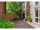 Front entrance with brick walkway and garden beds, offering a welcoming curb appeal at 49 Willow Gln, Atlanta, GA 30342