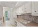 Bright kitchen featuring white appliances and decorative backsplash tiles at 49 Willow Gln, Atlanta, GA 30342