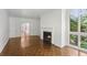 Bright living room with fireplace, hardwood floors, and a large window overlooking lush greenery at 49 Willow Gln, Atlanta, GA 30342