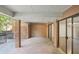 An outdoor covered patio with brick flooring and walls, and a sliding glass door at 49 Willow Gln, Atlanta, GA 30342