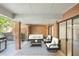 Covered patio with brick pillars, comfortable seating, and a grill for outdoor entertainment at 49 Willow Gln, Atlanta, GA 30342