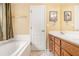 This bathroom features a bathtub, vanity, and tiled floor, providing a functional and comfortable space at 1335 Vine Cir, Mcdonough, GA 30253