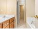 This bathroom features a tiled floor, vanity, and a bathtub, providing a functional and comfortable space at 1335 Vine Cir, Mcdonough, GA 30253