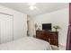 This bedroom features a dresser with a television, a ceiling fan and closet space at 1335 Vine Cir, Mcdonough, GA 30253