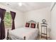 This bedroom features a ceiling fan and natural light from the window and closet space at 1335 Vine Cir, Mcdonough, GA 30253