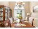Formal dining room featuring hardwood flooring, a chandelier, and a china cabinet at 1335 Vine Cir, Mcdonough, GA 30253