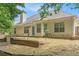 Exterior view of the home showing the backyard with a brick patio and chimney at 1335 Vine Cir, Mcdonough, GA 30253
