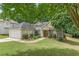Attractive home featuring landscaped yard, stone accents, and an attached two-car garage at 1335 Vine Cir, Mcdonough, GA 30253
