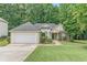 Charming single-story home with well-manicured lawn, attached garage, and lovely landscaping at 1335 Vine Cir, Mcdonough, GA 30253
