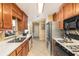 Functional kitchen featuring stainless steel appliances, laminate counters, and ample cabinetry at 1335 Vine Cir, Mcdonough, GA 30253