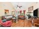 Bright living room with high ceilings, wood floors, fireplace, and comfortable seating at 1335 Vine Cir, Mcdonough, GA 30253
