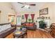 Cozy living space with vaulted ceilings, wood floors, fireplace and access to a sunroom at 1335 Vine Cir, Mcdonough, GA 30253