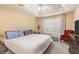 Cozy main bedroom showcasing a tray ceiling, natural lighting, and a sitting area at 1335 Vine Cir, Mcdonough, GA 30253