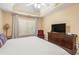 Comfortable main bedroom features a tray ceiling, TV, and carpeted flooring at 1335 Vine Cir, Mcdonough, GA 30253