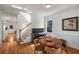 A Dining Area situated next to a staircase with lots of light and hardwood floors at 174 Crumley St, Atlanta, GA 30312