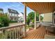 Inviting front porch with swing, wicker seating and wood floors overlooking the landscaped front yard at 174 Crumley St, Atlanta, GA 30312