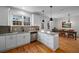 A kitchen features white cabinets, granite countertops, stainless steel appliances, and hardwood floors at 174 Crumley St, Atlanta, GA 30312