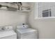 Bright laundry room with shelving, washer, dryer and window at 174 Crumley St, Atlanta, GA 30312
