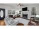 Bright living room featuring a fireplace, hardwood floors, modern decor, and comfortable seating at 174 Crumley St, Atlanta, GA 30312