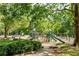 A large playground with slides, swings, and climbing structures amidst a leafy, green park setting at 174 Crumley St, Atlanta, GA 30312