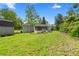 The backyard features a shed, lush grass, and mature trees at 1903 Lochlomand Se Ln, Smyrna, GA 30080