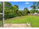 Spacious backyard featuring mature trees, lush grass, and a wooden deck at 1903 Lochlomand Se Ln, Smyrna, GA 30080