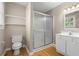 Bathroom with a glass-enclosed shower, white vanity and a large mirror at 1903 Lochlomand Se Ln, Smyrna, GA 30080
