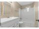Well-lit bathroom featuring a shower and tub combination, toilet, and a decorative mirror at 1903 Lochlomand Se Ln, Smyrna, GA 30080