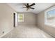 Neutral bedroom with large windows providing natural light, a ceiling fan, and a closet at 1903 Lochlomand Se Ln, Smyrna, GA 30080