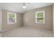 Well-lit bedroom featuring neutral wall color, plush carpet, and two large windows at 1903 Lochlomand Se Ln, Smyrna, GA 30080