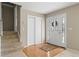 Spacious foyer with wood and carpeted flooring, closet, and glass front door at 1903 Lochlomand Se Ln, Smyrna, GA 30080