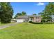 Charming two-story home with manicured lawn, attached garage, and inviting front porch at 1903 Lochlomand Se Ln, Smyrna, GA 30080