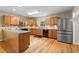 Kitchen featuring stainless appliances, tile backsplash, granite countertops, and wood cabinets at 1903 Lochlomand Se Ln, Smyrna, GA 30080