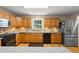 Kitchen featuring stainless appliances, granite countertops, tile backsplash and wood cabinets at 1903 Lochlomand Se Ln, Smyrna, GA 30080