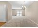 Spacious living room with neutral carpet, chandelier, and closet at 1903 Lochlomand Se Ln, Smyrna, GA 30080