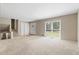 Bright living room with neutral carpet, large window, and front door access at 1903 Lochlomand Se Ln, Smyrna, GA 30080