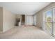 Bright living room with neutral carpet, large window, and front door access at 1903 Lochlomand Se Ln, Smyrna, GA 30080