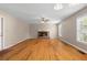 Spacious living room featuring a ceiling fan, hardwood flooring and stone fireplace at 1903 Lochlomand Se Ln, Smyrna, GA 30080