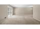 Bright living room with neutral carpet, large window, and ample space for entertaining at 1903 Lochlomand Se Ln, Smyrna, GA 30080